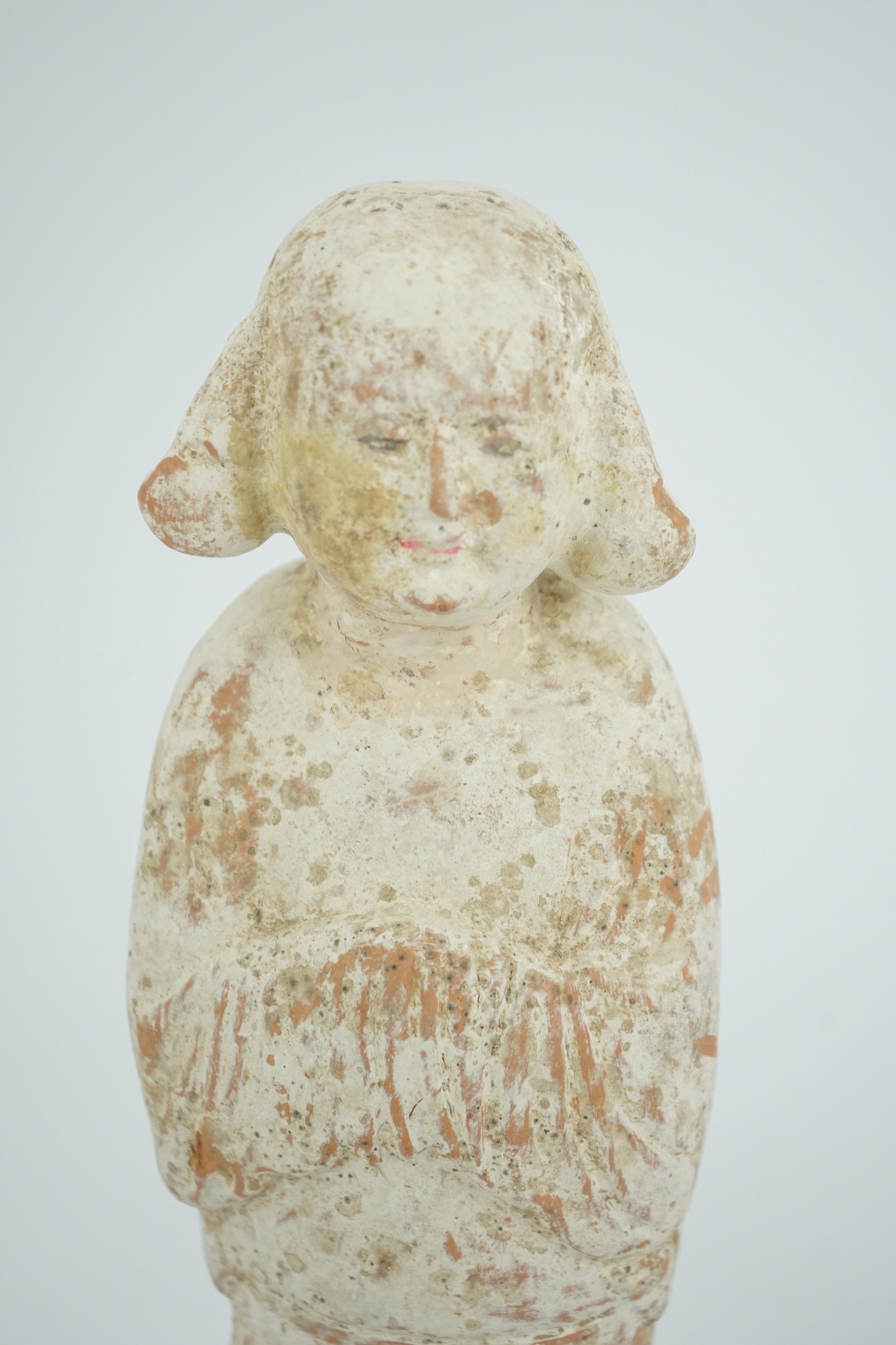 A Chinese painted pottery groom figure, Tang Dynasty (AD 618-906)